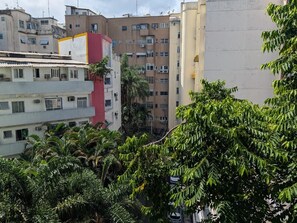 A multi-story building with balconies, surrounded by dense foliage. - Copanema Apartment (Rio de Janeiro)