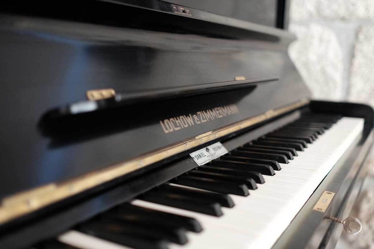 A piano with a visible brand name and a label.