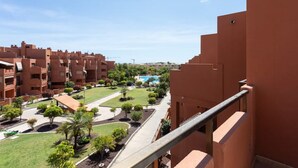 A residential area with multiple buildings, a swimming pool, and a well-maintained lawn.