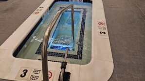 A hotel swimming pool area with two pools, one with a 3 feet deep sign, and a separate hot tub area. - Brand Newly Renovated Resort Style One Bedroom Luxury Suite Simplex (Montauk)