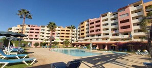 A hotel with a swimming pool, multiple floors, and balconies. - Albufeira Apartment, Pool and Sea View (Albufeira)
