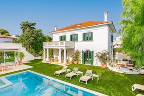A two-story house with a swimming pool, green shutters, and a covered patio. - Villa De Los Leones - Seven Bedroom Villa, Sleeps 19 (Sitges)