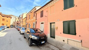 A street with parked cars and buildings with shutters. - P092 – Porto Recanati, three-room apartment  (Porto Recanati)