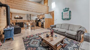 A loft-style living space with a kitchen, dining area, and a loft bedroom.