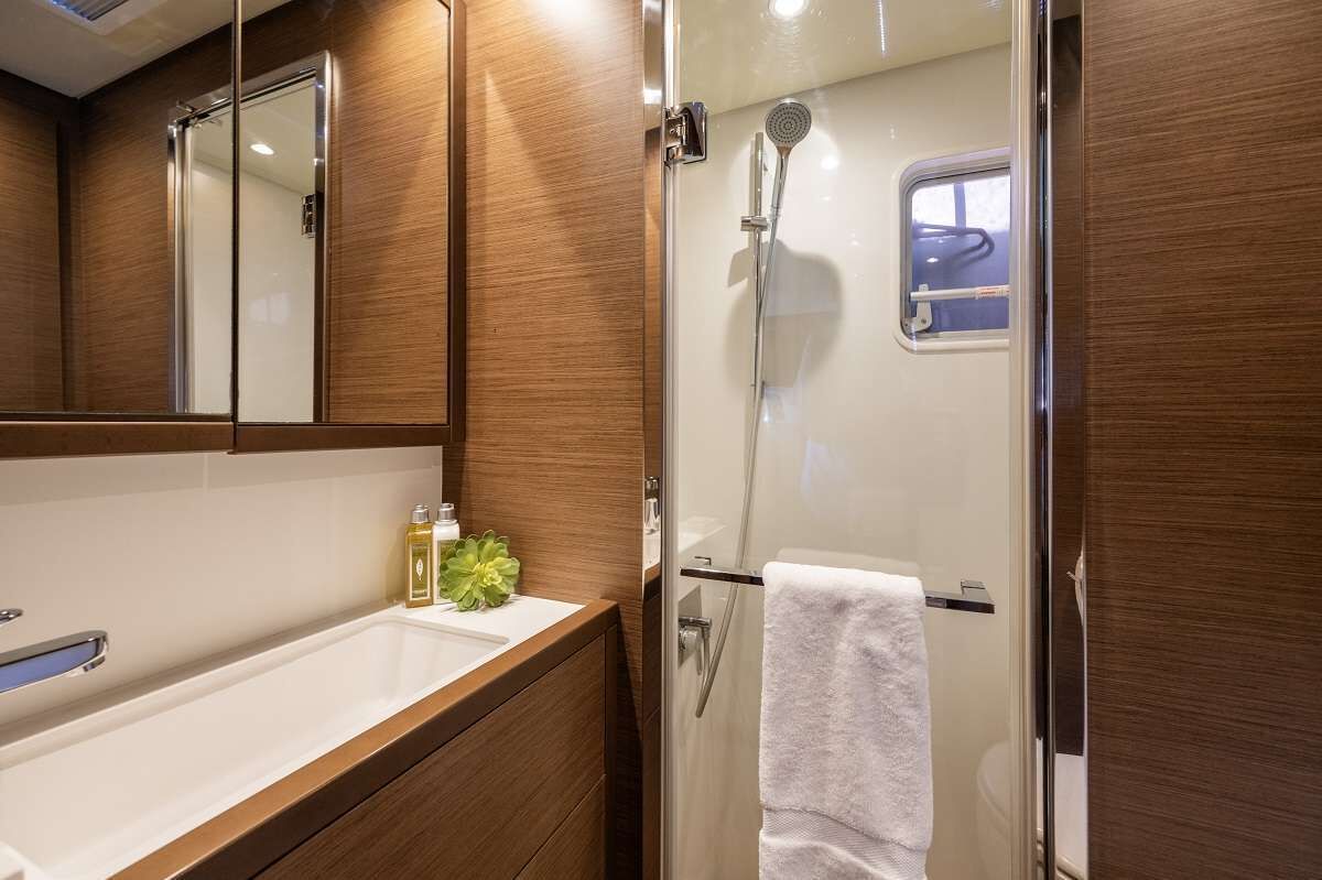 A bathroom with a shower, a sink, and a mirror.