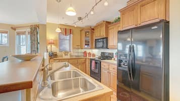 Dishwasher, coffee/tea maker, cookware/dishes/utensils, dining tables