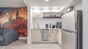 A modern kitchen with a dishwasher, microwave, and refrigerator. - Harry Potter Suite near Epic & Universal (Orlando)