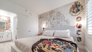 A bedroom with a large bed, a map on the wall, and a window with blinds. - Harry Potter Suite near Epic & Universal (Orlando)