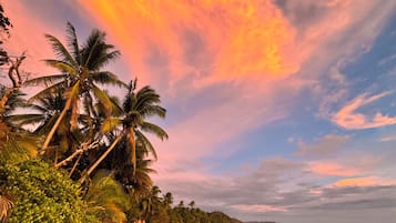 Beach nearby, white sand, beach umbrellas, beach towels