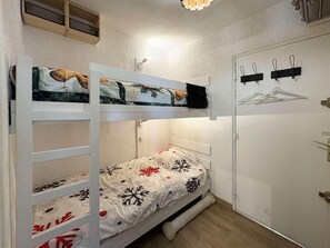A small, compact room with a bunk bed, a wardrobe, and a coat rack. - Ground floor, view mountain, balcony, tv, ski locker, 23m², Les Orres (Les Orres)