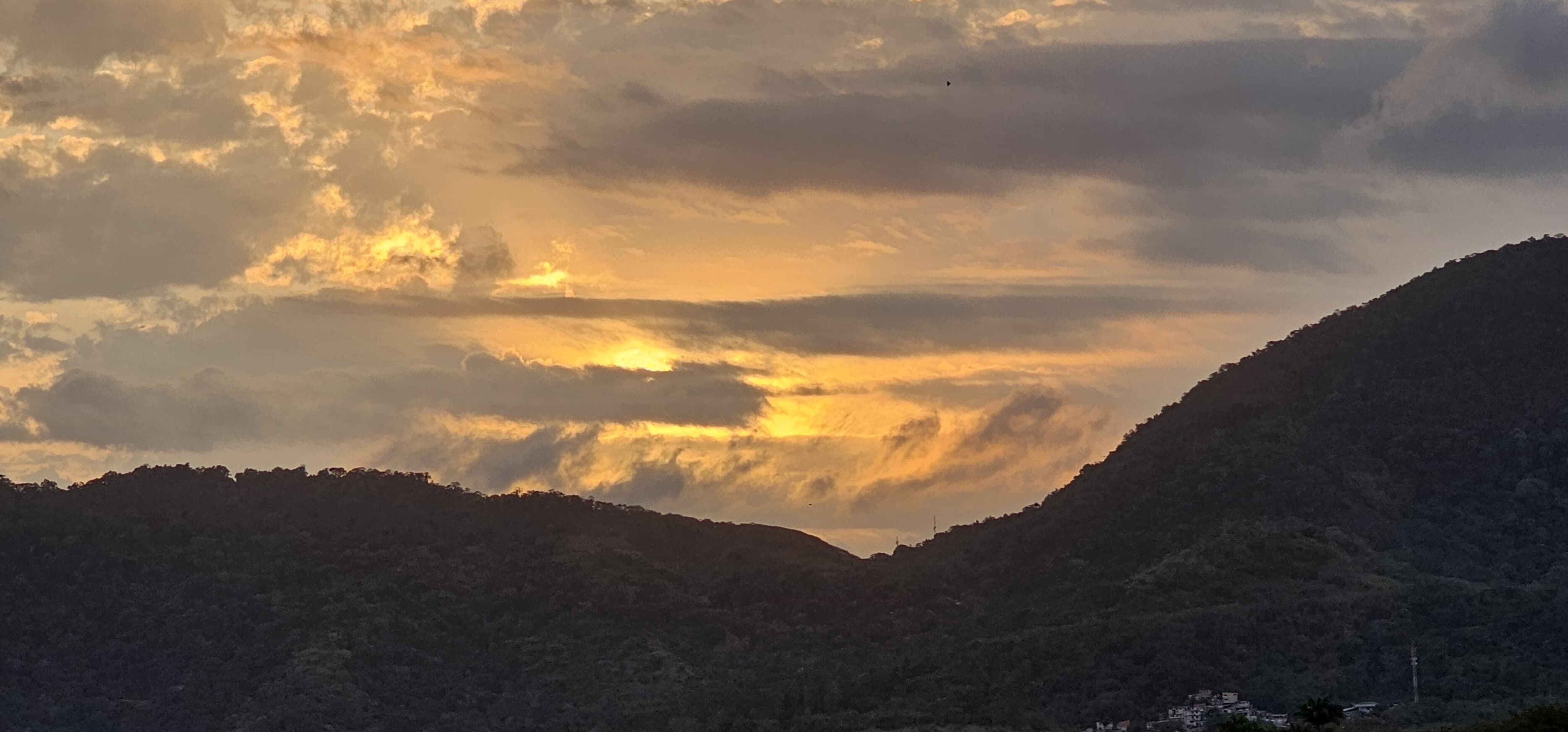 Un paisaje montañoso con un valle y una colina en primer plano.