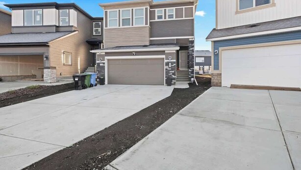 A residential area with modern houses, a driveway, and a garage.