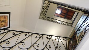 A staircase with ornate black metal railings and a handrail. - CHARMING LUCCA (Lucca)