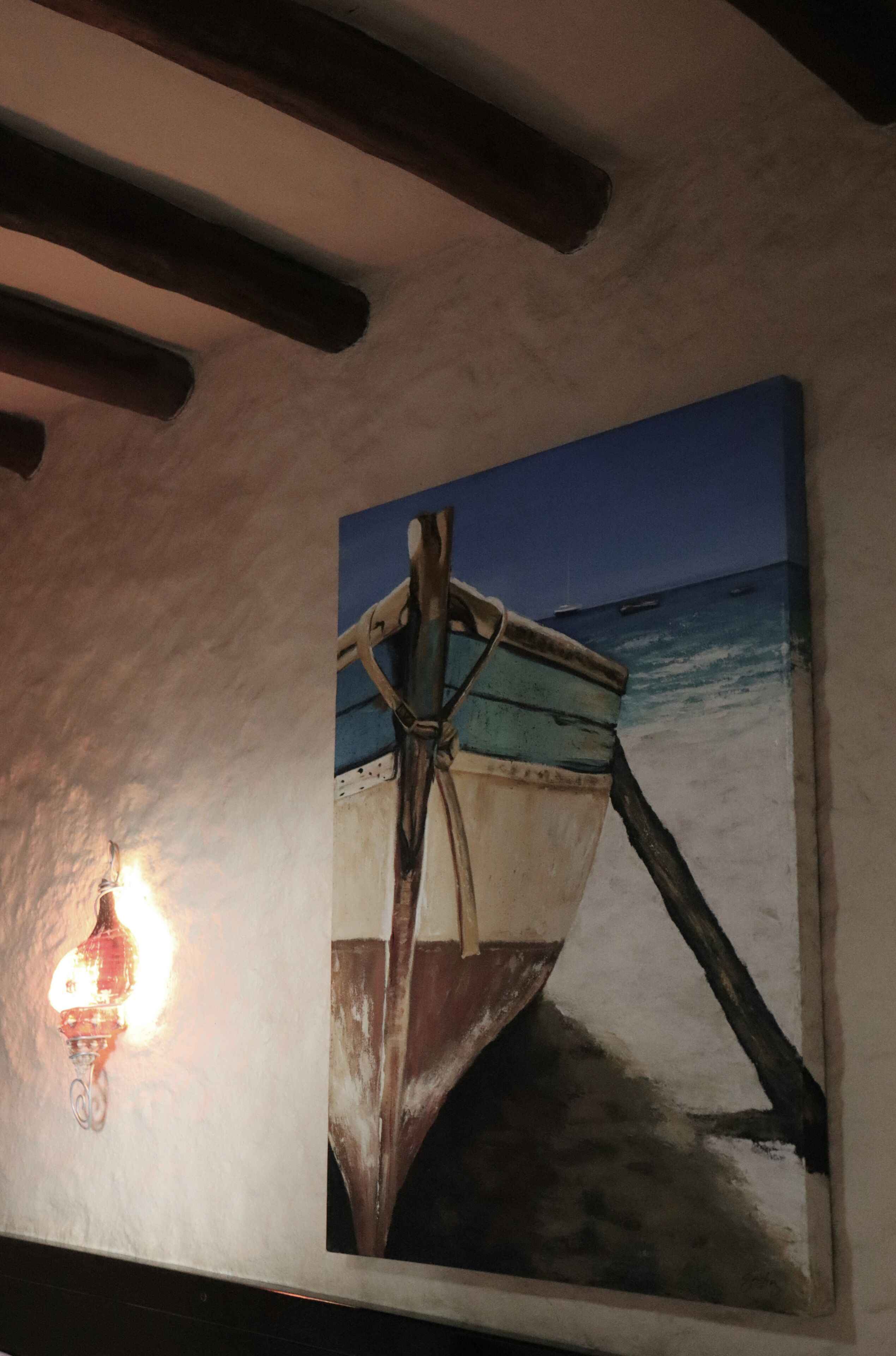 A painting of a boat on a beach.