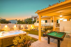 A pool area with a hot tub, lounge chairs, and a pool table. - Spacious Villa w/ Jacuzzi • Close to the Beach • Free WiFi (Albufeira)
