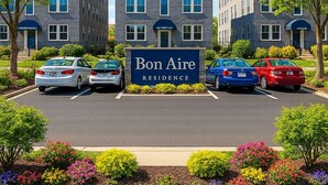 A residential complex with a central building labeled 'Bon Aire Residence,' surrounded by parking spaces and landscaped gardens. - Fully Renovated 1BR  Walk to Hospitals University Parking (Indianapolis)