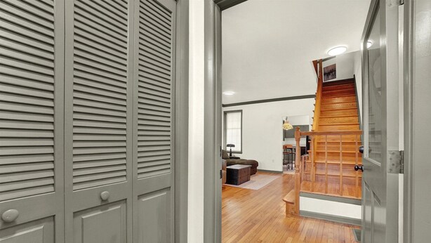 A hallway with a wooden staircase, a sofa, and a coffee table in the background. - NEW Downtown York 2B Getaway. Modern Comfort. (York)