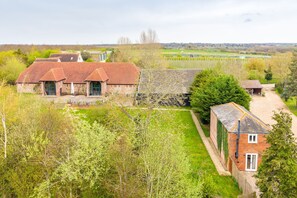 A rural property with multiple buildings, including a main house with a large garden and a smaller structure. - The Cottage at Tuffon Hall, Sible Hedingham, Suffolk (Sible Hedingham)