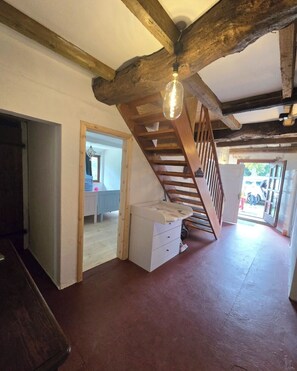 A rustic interior with exposed wooden beams, a staircase, and a light fixture. - David & Marion's Vacation Rental: 7 minutes from Karls Erlebnisdorf/Bremerhaven and the Weser beach. (Loxstedt)