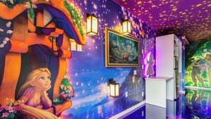 A room with a mural, a white cabinet, and a window with a reflection. - Rapunzel themed studio w/ pool & workspace (Kissimmee)