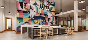 A reception area with a colorful geometric wall mural, a reception desk, and a seating area with wooden chairs. - Modern Comfort Vibes with Desk, Balcony & Near UC (Cincinnati)