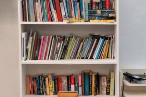 A bookshelf filled with books. - Oceanfront 2-BR in Marbella  Private Beach + View (Playa Juan Dolio)