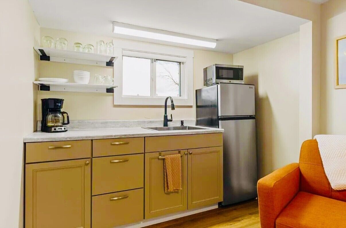 Fridge, microwave, coffee/tea maker, cookware/dishes/utensils