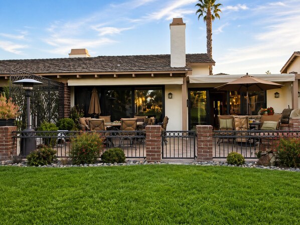 A house with a patio area featuring outdoor furniture and a brick fence. - Condo in Palm Desert, California (Palm Desert)