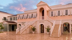 A building with a central staircase, a covered area, and a sign reading 'Town Hall'. - A beautifully appointed 2-bdrm, 2-bath resort villa atop Barbados’ most celebrated cliffside, w/ panoramic ocean views & designer interiors. Dedicated concierge service & complimentary airport transfers. (St. Philip)