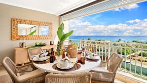 A dining area with wicker chairs, a round table, and a view of the ocean. - A beautifully appointed 2-bdrm, 2-bath resort villa atop Barbados  ’ most celebrated cliffside, w/ panoramic ocean views & designer interiors. Dedicated concierge service & complimentary airport transfers. (St. Philip)