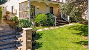 A house with a front porch, steps leading to the entrance, and a well-maintained lawn. - A Peaceful Haven Only A Few Minutes Walk To Town (KATOOMBA)