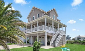 A two-story beachfront house with a balcony, a covered porch, and a staircase leading to the upper level. - Alamo Sea!  Your Pointe West Private Getaway 2 Primary Bedrooms (Galveston)