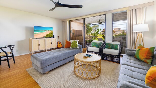 A modern living room with a sofa, armchair, and a round coffee table. - Paradise Awaits at This Beautiful Waikoloa Village Condo! (Waikoloa Village)
