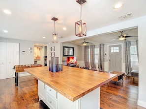 A spacious kitchen with a large island, pendant lighting, and a ceiling fan. - Private Pool, Games, Firepit Ultimate Tampa Fun House (Tampa)