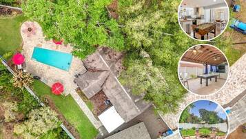 An aerial view of a property with a swimming pool, patio area, and a covered outdoor seating area.