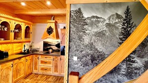 A wooden interior with a kitchen, wooden cabinets, and a staircase. - Delightful 2-bedroom cottage in charming Ząb for your getaway (Ząb)