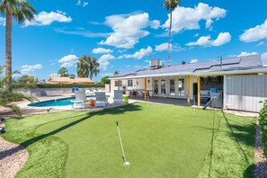 A residential property with a swimming pool, a lawn, and a covered patio area. - Heated Pool! Minutes from Old Town Scottsdale. Dual Primary BDRS. (Scottsdale)