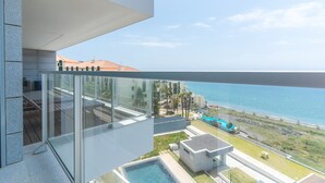 A modern balcony with a glass railing overlooking a pool and a coastal view. - La Belle Vie by Atlantic Holiday (Funchal)