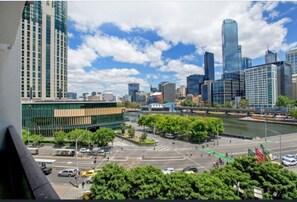 A cityscape with modern buildings, a river, and a green park area. - Queensbridge Luxe - Balcony - Casino & Arts Precinct - Front Row - Parking (Southbank)