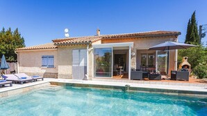 A house with a swimming pool, outdoor seating, and a covered patio. - Villa Repose by Villa Plus (Argeliers)