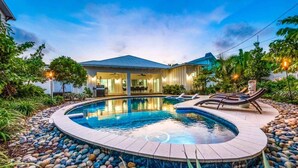 A swimming pool with a hot tub, lounge chairs, and a house with a covered patio. - Bahama Mama | Tropical Retreat on Siesta Key (Siesta Key)