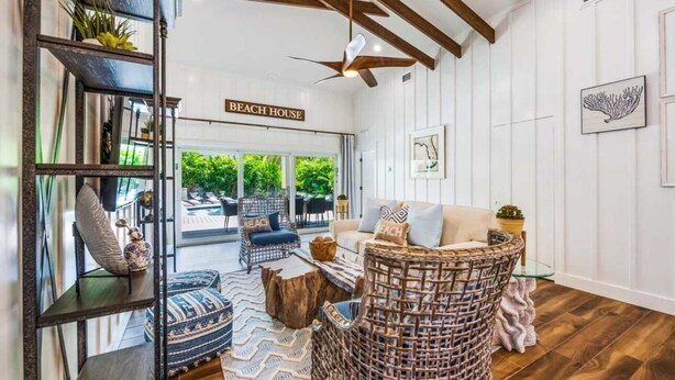 A beach-themed living room with a sofa, wicker chairs, and a ceiling fan. - Bahama Mama | Tropical Retreat on Siesta Key (Siesta Key)