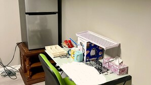 A compact kitchenette with a microwave, refrigerator, and a small table with various items. - Enjoyable 2-bedroom Max 4 guests in lower level with AC in vibrant inner-city (Calgary)