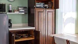 A kitchen with a microwave, coffee maker, toaster, and cabinets. - Retro 1BR Flat in the Heart of East Liberty | Queen Bed | Longer Stays Welcome (Pittsburgh)