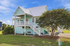 A two-story house with a balcony, a staircase, and a tree in the front yard. - Coming Soon: Check out this gem at The Point.  4BR, 3BA, 3-minute walk to beach. (Emerald Isle)