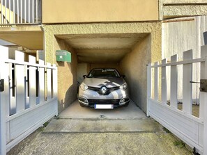 A car parked in a narrow driveway with a white fence on both sides. - CAP D'AGDE - Plage du Môle / Réf 319 (CAP D'AGDE)