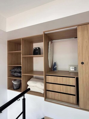 A modern storage unit with multiple compartments, a small heater, and a security lock. - NOK Beautiful Apartment in Chico (Bogotá)