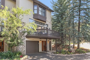 A multi-story residential building with a covered entrance and a balcony. - Offerson Chalet in Beaver Creek (Beaver Creek)