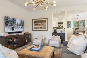 A modern living room with a television, seating, and a coffee table. - Offerson Chalet in Beaver Creek (Beaver Creek)