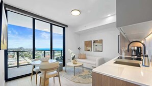 Een modern appartement met een balkon, een eetgedeelte, een woonkamer en een keuken.